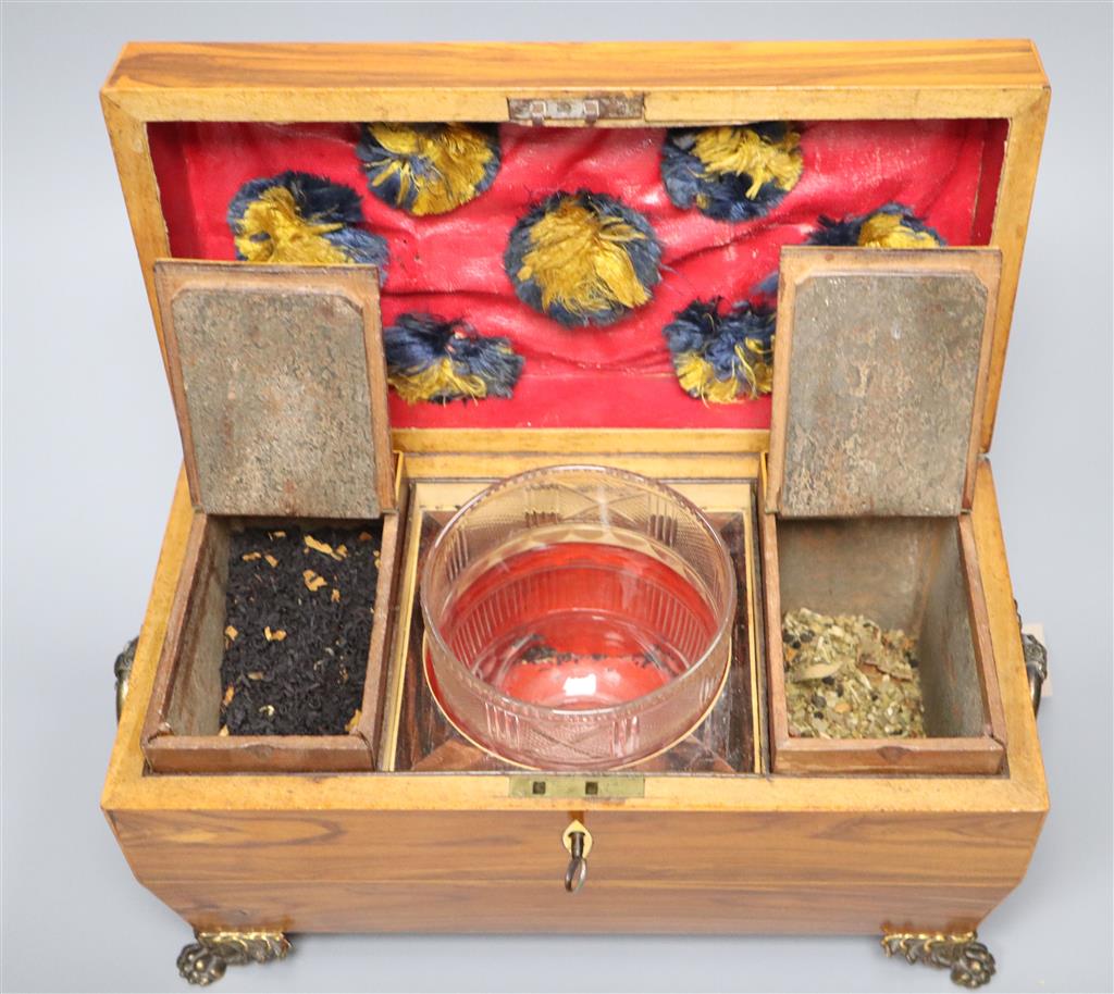 A Regency kingwood sarcophagus tea caddy fitted two containers and a cut glass bowl